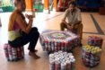 A man and a woman sit on furniture made out of ecobricks