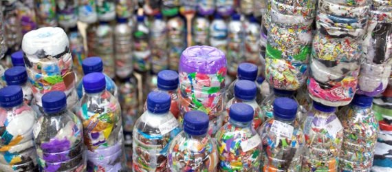 A wall of ecobricks, made from plastic trash stuffed into plastic bottles.