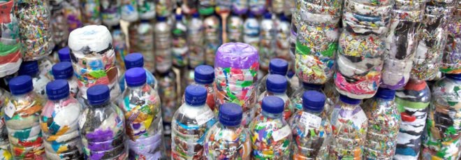 A wall of ecobricks, made from plastic trash stuffed into plastic bottles.