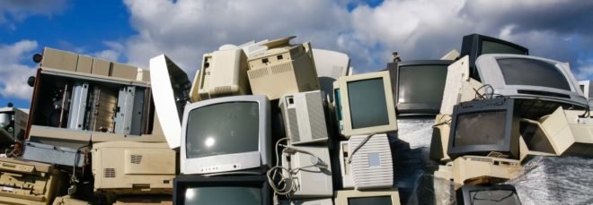 A pile of old TV and computer monitors