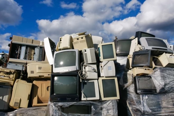 A pile of old TV and computer monitors