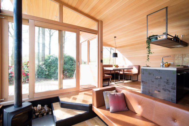 large windows let in natural light to a wooden interior