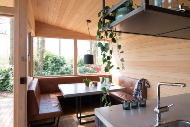 dining nook with large window and wooden walls