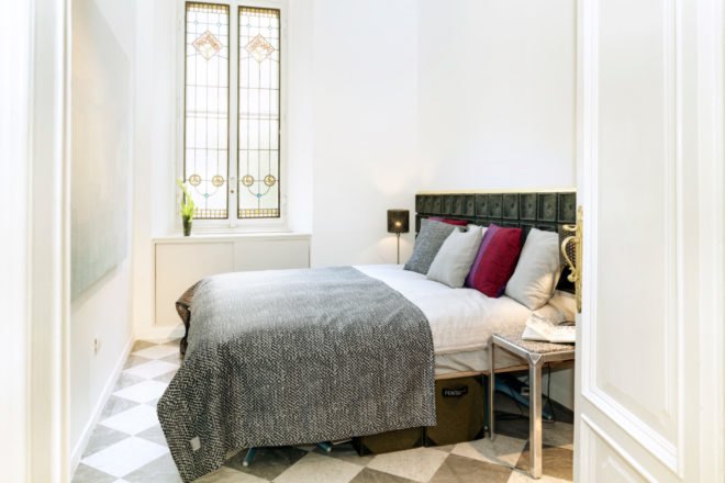 white room with a large bed