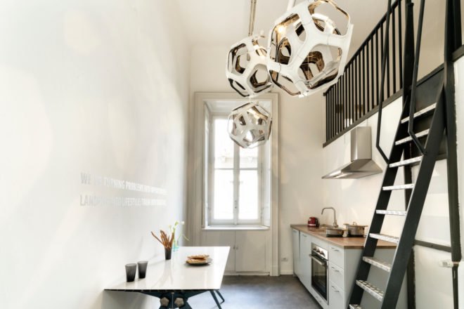 a kitchen space with geometric hanging lights