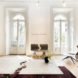 a living room with a chair and table that appear to have a divide in the midway point of each piece of furniture