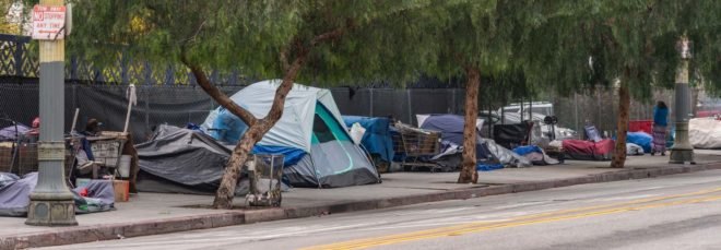 A row of tents on a city sidewalk