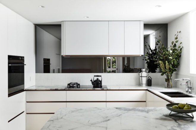 A modern kitchen with white cabinets and countertops.