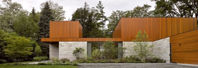 The exterior of a stone and timber house in the forest