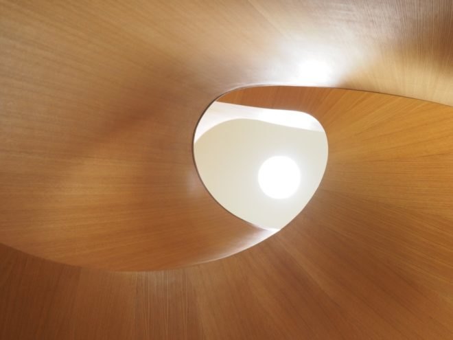 A view up the center of a wooden spiral staircase