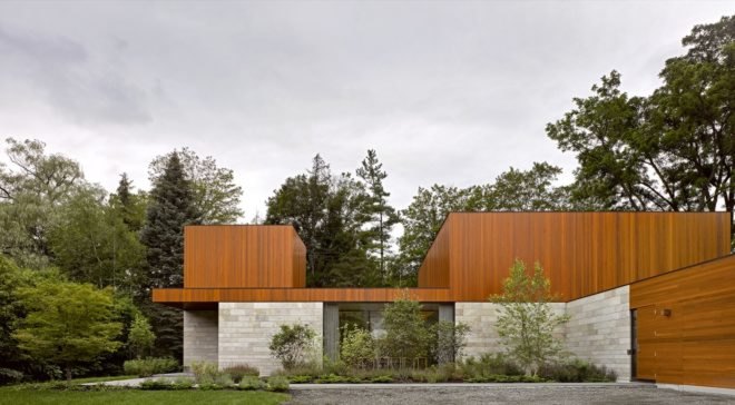 The exterior of a stone and timber house in the forest