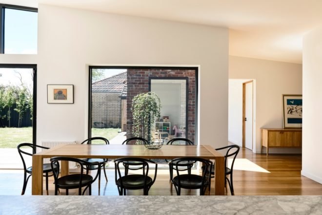 an open plan dining room with table and chairs