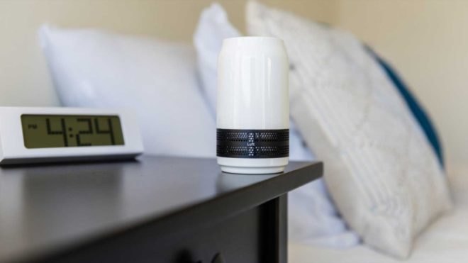 Small white soda can-sized air purifier on a nightstand
