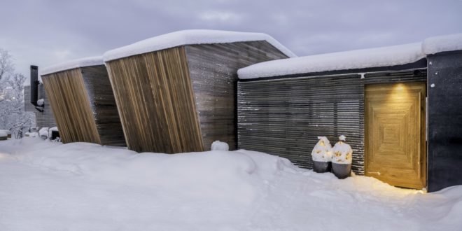wooden cabins covered in snow