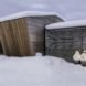 wooden cabins covered in snow