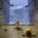 child lying on floor looking out of the window