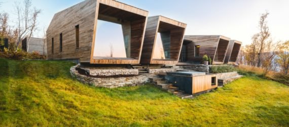 Series of wooden cabins with glass facades