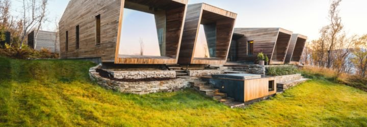Series of wooden cabins with glass facades