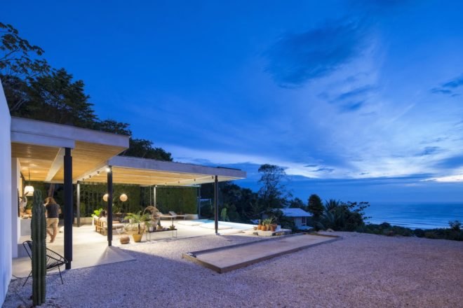 A nighttime view of the ocean from a hotel terrace.