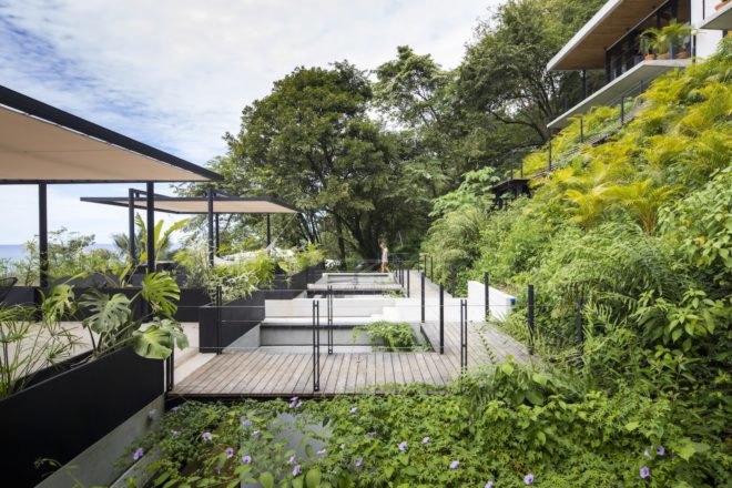 Hotel terraces surrounded by tropical greenery.