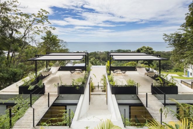 A hotel patio with a view of the ocean.