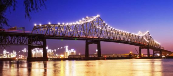 A lit-up bridge spanning the Mississippi River at night