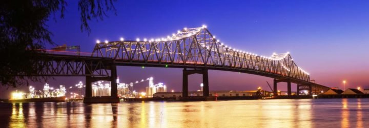 A lit-up bridge spanning the Mississippi River at night