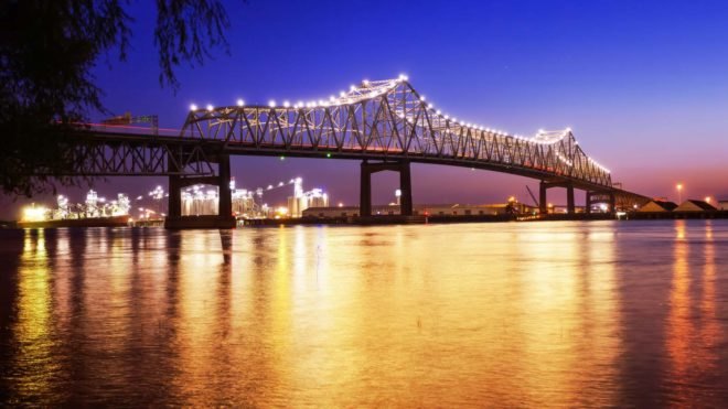 A lit-up bridge spanning the Mississippi River at night