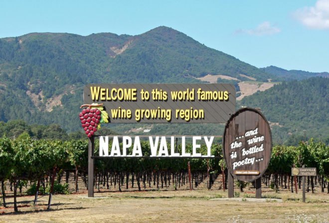Napa Valley sign reads "Welcome to this world famous wine growing region: Napa Valley."
