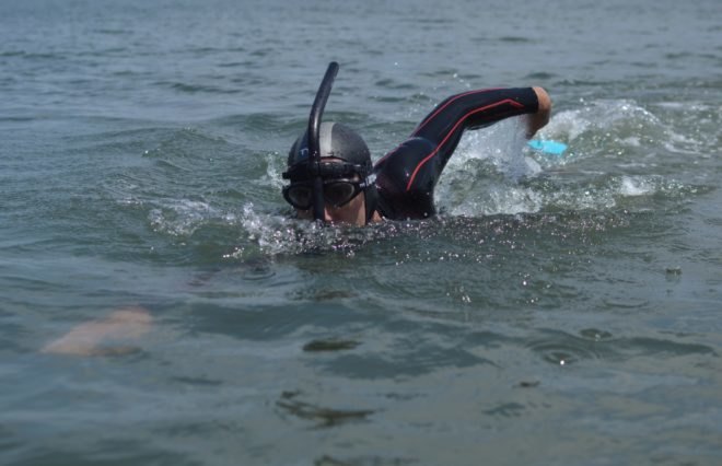 Professional long distance swimmer Ben Lecomte swimming in the waves