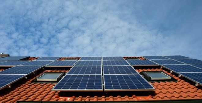 A red tile roof is equipped with rooftop solar panels to generate clean energy