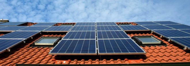 A red tile roof is equipped with rooftop solar panels to generate clean energy