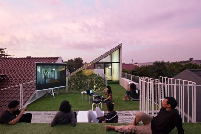 People hanging out on the green roof at dusk