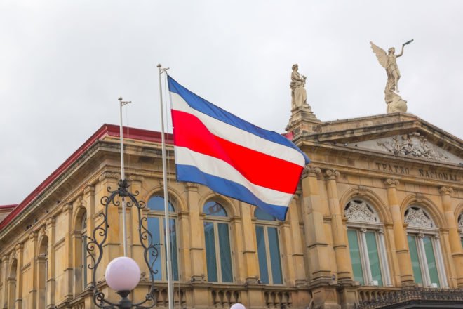 Flag of Costa Rica in front of the San Jose National Theater
