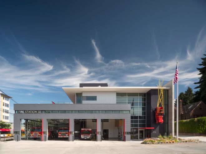 View of the station during the day with fire trucks in the driveway