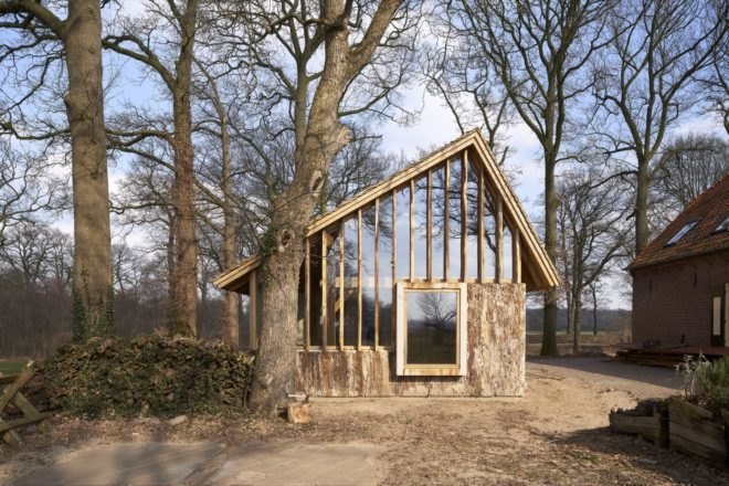 front view of an oak barn with nearby trees