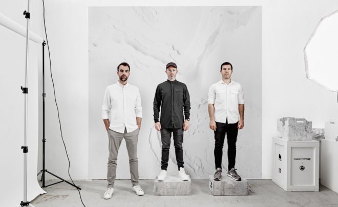The team members of Snarkitecture standing in front of a white sheet