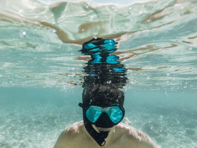 Snorkeler in Hawaii near coral