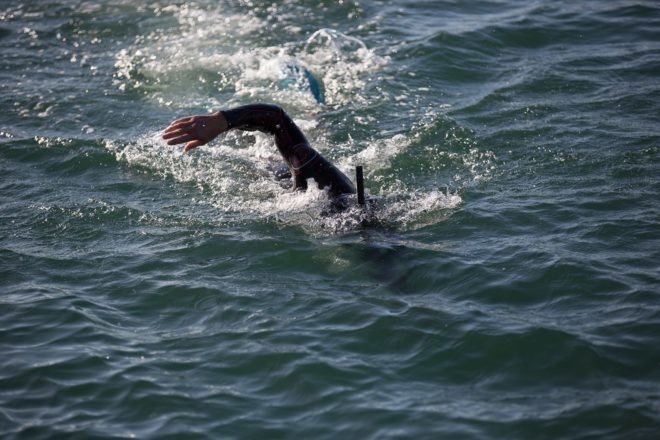 Professional long distance swimmer Ben Lecomte swimming in the waves