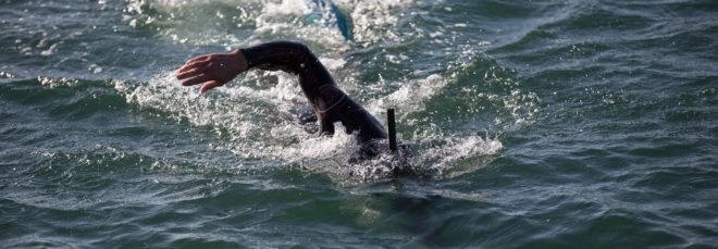 Professional long distance swimmer Ben Lecomte swimming in the waves