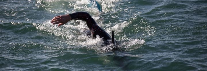 Professional long distance swimmer Ben Lecomte swimming in the waves