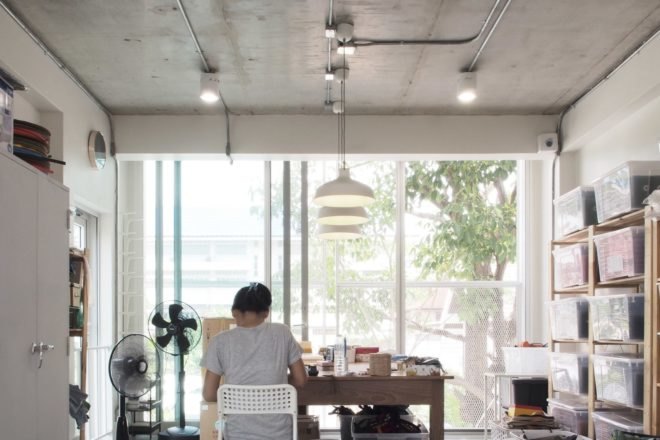 person working at a desk inside a white interior