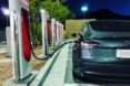 Tesla electric car charging at a station