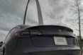 Tesla car near the Arch of St. Louis