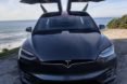 Tesla Model X near the ocean with its doors open