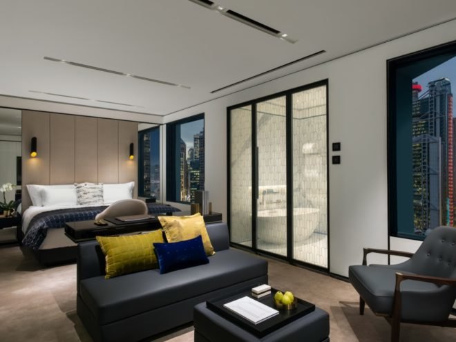 hotel room with couch and large windows
