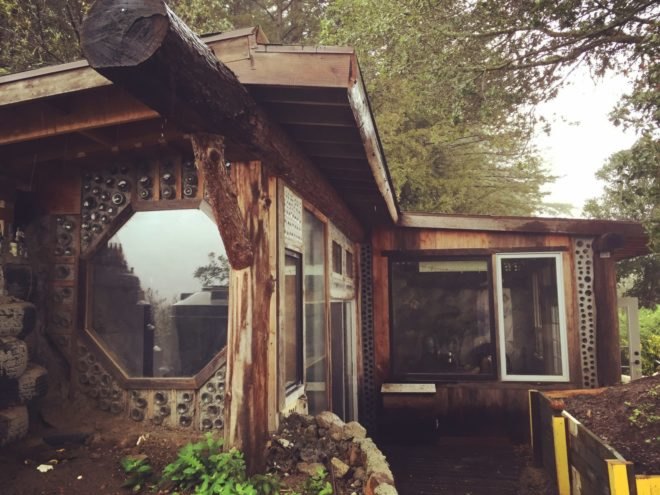 a wooden home with windows of varying shapes and sizes