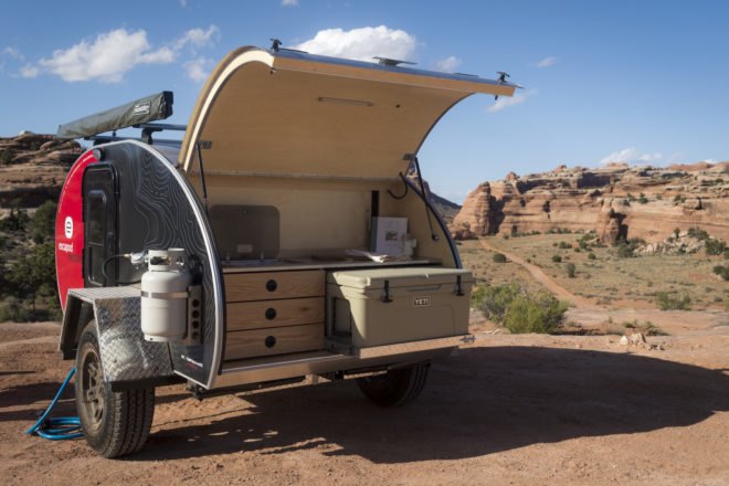 A small kitchen in a trailer's rear storage compartment.