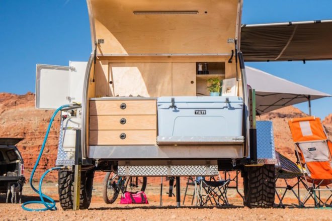 A small kitchen in a trailer's rear storage compartment.