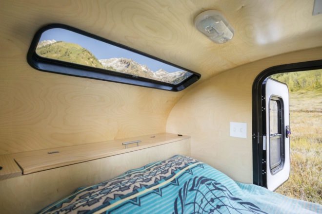 A sleeping compartment with a queen-sized mattress.
